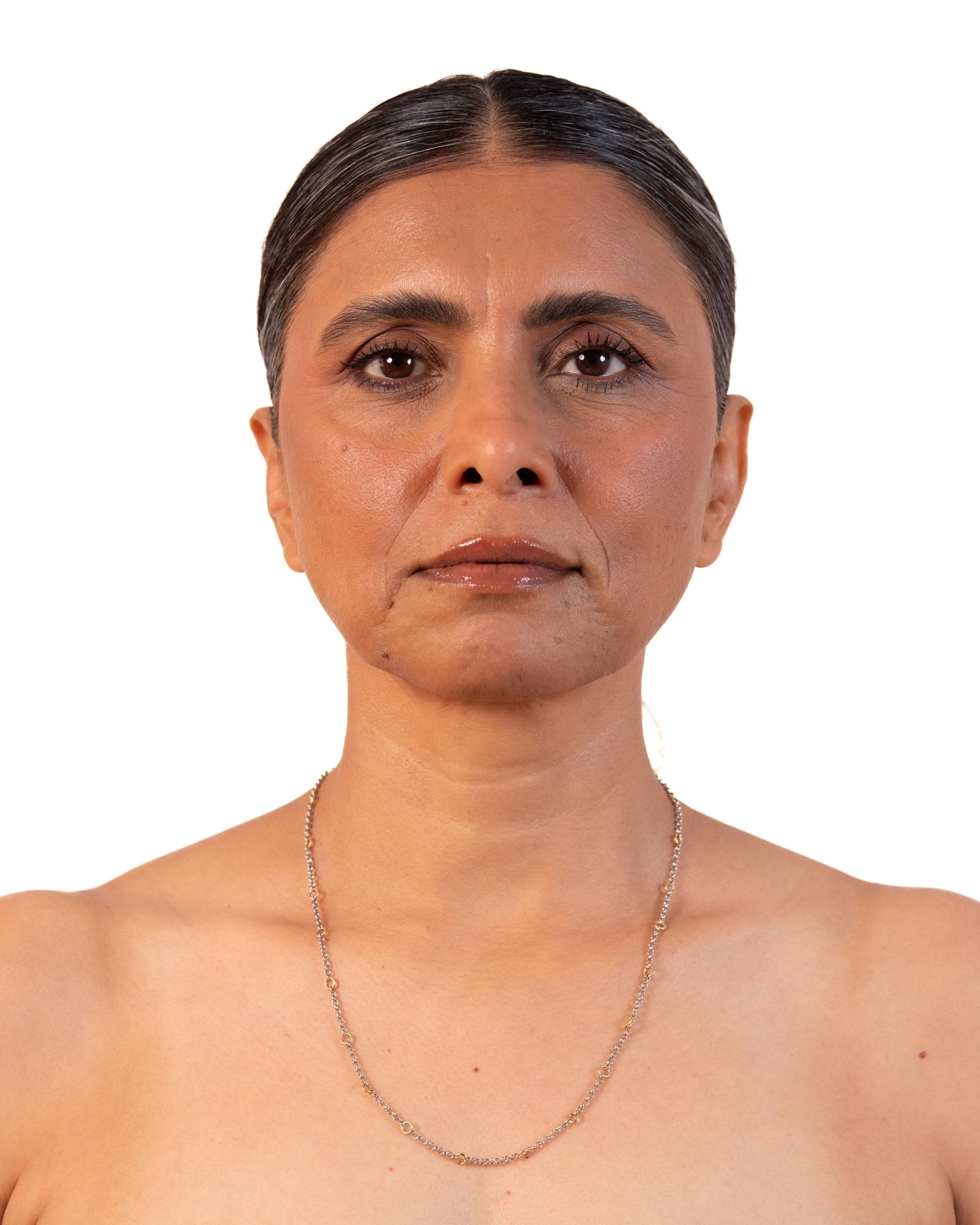 Close-up of a delicate MAISON MEGH Tiny Linky Chain Circle jewelry piece with small interconnected links.